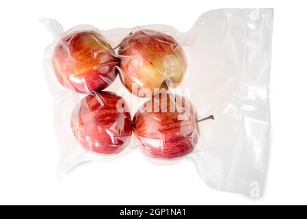 Four whole red apples in vacuum packed sealed for sous vide cooking isolated on white Stock Photo