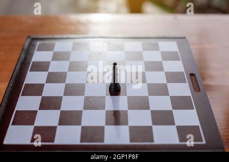 Closeup of the black king alone on the board. Stock Photo