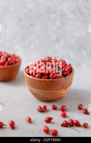 Medicinal plants and herbs. Rose hips berries on concrete background with copy space. Dried fruits for herbal teas and essential oils. Selective focus Stock Photo