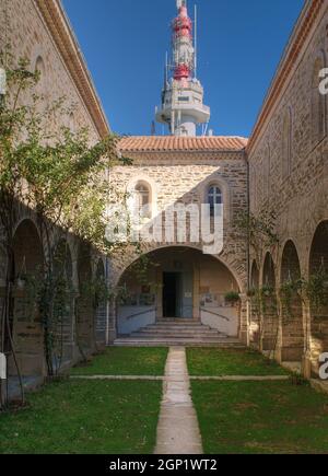 View Into The Courtyard Of A Monastery With A Radio Tower Behind In Provence France On A Beautiful Autumn Day With A Clear Blue Sky Stock Photo