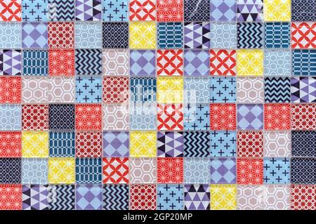 Multicolored ceramic mosaic tiles in patchwork style. Stock Photo