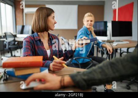 Two female IT specialists works on computers in office. Web programmer or designer at workplace, creative occupation. Modern information technology, c Stock Photo