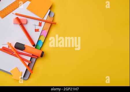 Office stationery supplies on opened notepad closeup. School or education accessories, writing and drawing tools Stock Photo
