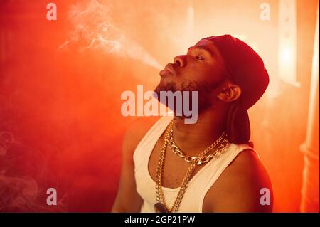 Smoke Wavy Rapper Stylish rapper exhales smoke in studio Stock Photo - Alamy