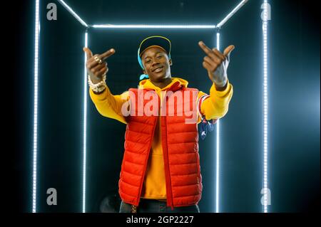 Smiling rapper on the stage with illuminated cube Stock Photo - Alamy