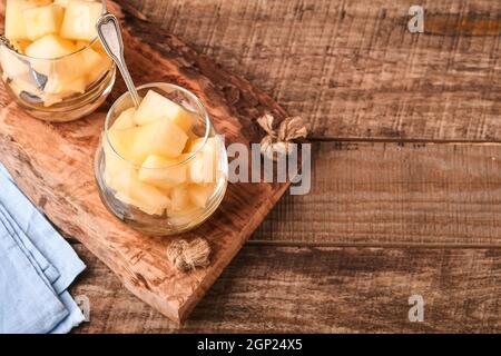 Melon. Pieces of fresh melon for making fruit dessert in glass on an old wooden background. Mock up. Top view. Stock Photo