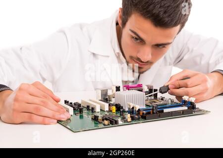 A computer engineer or technician, working on a computer motherboard Stock Photo