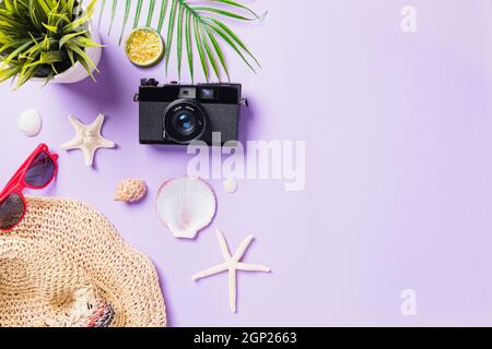 Top view flat lay mockup of camera films, airplane, sunglasses, starfish beach traveler accessories isolated on a purple background with copy space, B Stock Photo