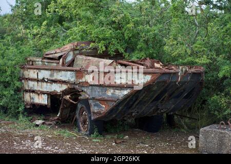 Rusting and abandoned DUKW vehicle (a six-wheel-drive amphibious truck used in World War II on D-Day) at RAF Folkingham, Lincolnshire, UK. Stock Photo