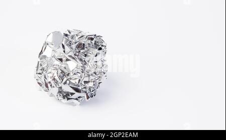 crumpled piece of gray foil on a white background, copy space Stock Photo