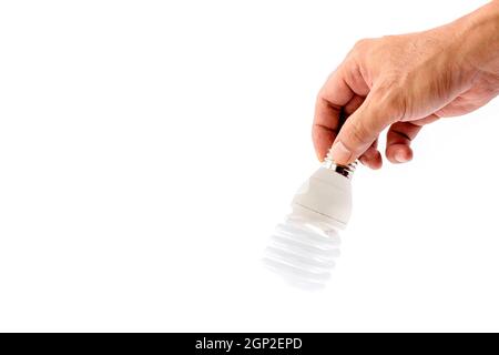 Human hand holding fluorescent light bulb isolated on white background. Stock Photo