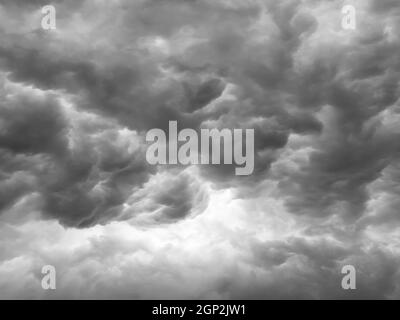 Black clouds formed before the rain. Ominous storm clouds. Sky before a thunderstorm. Used to make a background image. Stock Photo