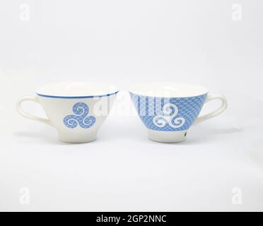 white and blue cup with a blue breton pattern on a white background. Stock Photo