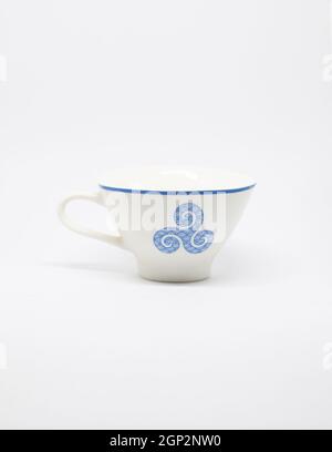 white and blue cup with a blue breton pattern on a white background. Stock Photo