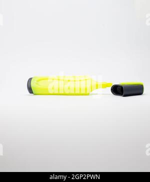 Yellow marker with cap off on a white background. Stock Photo