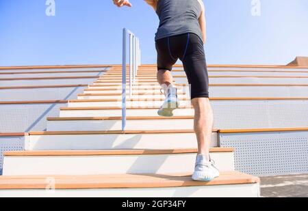 young man running upstairs at  stadium Stock Photo