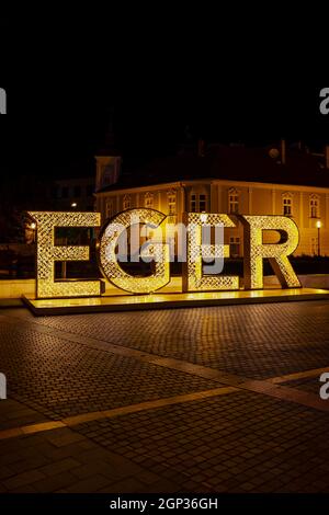 illuminated sign Egger in center of historic city, Northern Hungary Stock Photo