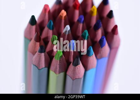 Multi-colored pencils sharpened on a white background, depth of field. Background. Stock Photo