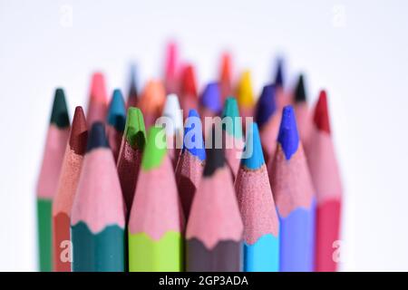 Multi-colored pencils sharpened on a white background, depth of field. Background. Stock Photo