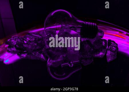 Painting with light on a mirror with small colored lamps and a lightbulb. Stock Photo