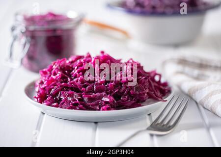 Red sauerkraut. Sour pickled cabbage on plate. Stock Photo