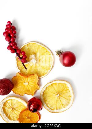 Set of dried slices and half a slice of orange and lemon, isolated on white background with christmas decoration. Stock Photo