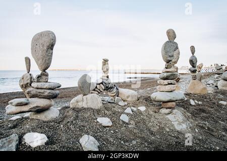 Figures of stones on the beach near the sea. Sea background and stone figures. Stock Photo