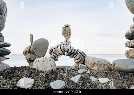 Figures of stones on the beach near the sea. Sea background and stone figures. Stock Photo
