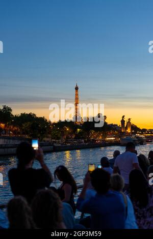 Group of tourists taking photos of the Eiffel Tower in Paris, France Stock Photo
