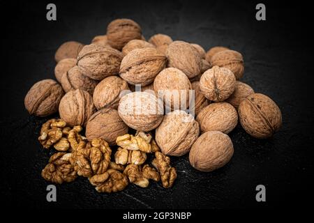 Walnut on over black slate stone background Stock Photo