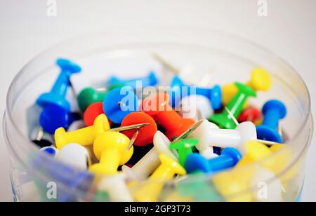Heap of colorful office push pins on white background. Stock Photo