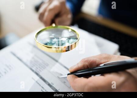 Fraud Detective Using Magnifying Glass Or Loupe Stock Photo