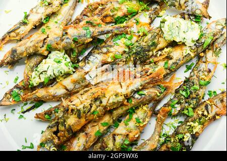 Fried capelin fish with herbs and lemon zest Stock Photo