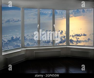 Cozy room overlooking clouds above sea. Landscape with clouds above ocean. Window with beautiful celestial panorama. Veranda window overlooking the se Stock Photo