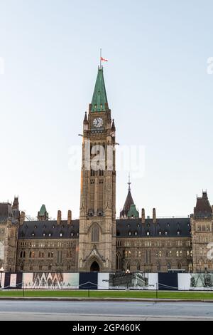 Ottawa, Canada - September 19, 2021: Parliament building with canadian flag in downtown of the capital Stock Photo