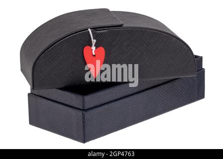 Closeup of a closed sturdy (hardcase) black luxury leather glasses case with a small red heart on an opened gift box isolated on white. Valentine's Da Stock Photo