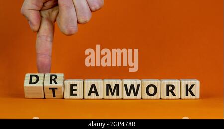 Teamwork and dream work symbol. Businessman turns wooden cubes and changes the word 'dreamwork' to 'teamwork'. Beautiful orange background. Business, Stock Photo
