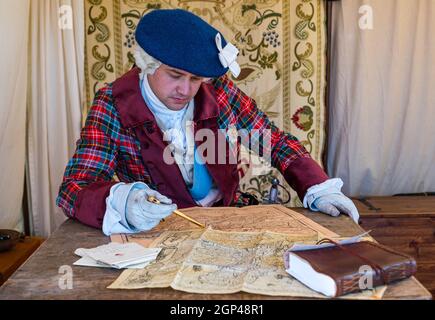 Dr Arran Johnstone as Bonnie Prince Charlie in period costume studies old maps in re-enactment of Battle of Prestonpans, East Lothian, Scotland, UK Stock Photo