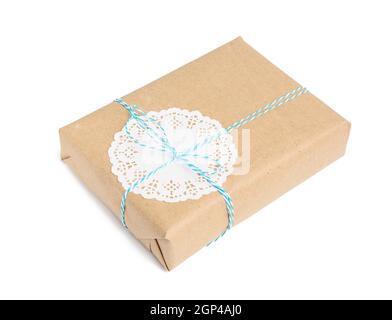 box wrapped in brown kraft paper and tied with blue rope, gift isolated on white background Stock Photo