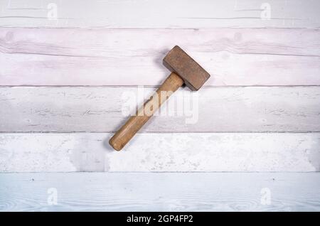 Hammer mason or mass on a background of old boards. Top view. Stock Photo