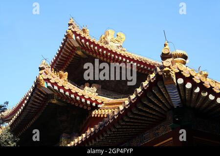 Tiled roof and facade decorated with a Chinese pattern. Palace in The Forbidden City, Beijing, China Stock Photo