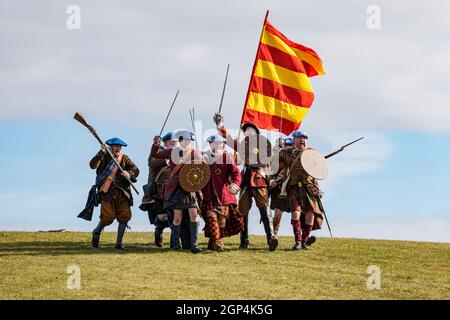 Jacobite Scotsmen in period costume charging for re-enactment of Battle of Prestonpans , East Lothian, Scotland, UK Stock Photo