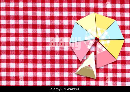 Top view of various blank paper packages with processed cheese triangles on a red checkered blanket. One of it is open.Template for your food and prod Stock Photo