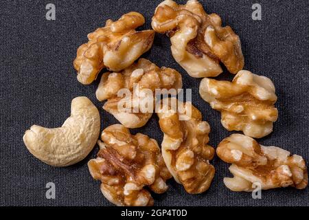 Kernels of cashews and walnuts lie on a dark cloth background Stock Photo