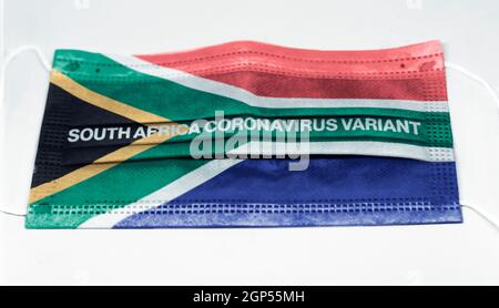 the South Africa flag printed on a surgical mask with the indication of the new corona virus variant. Health and medicine. Global pandemic Stock Photo