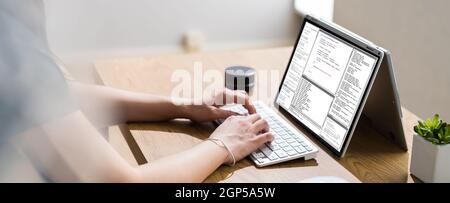 Coder Or Software Developer Using Laptop Screen In Office Stock Photo