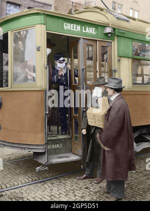 Spanish Flu Epidemic 1918-1919. During the influenza epidemic, Seattle, Washington, conductors refuses entrance to the streetcar to a man without wearing a mask, December 1918. The Red Cross made and distributed 260,000 masks to protect the city's population.  (BSIC 2020 7 1)