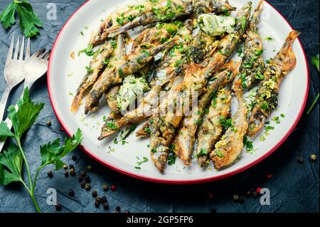 Fried capelin fish with herbs and lemon zest.Fish dish Stock Photo