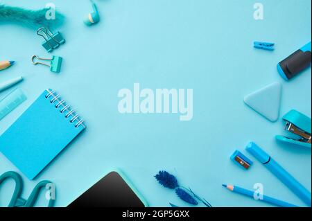 Office stationery supplies in blue tones. School or education accessories, writing and drawing tools, pencils and pens, clips and notepad Stock Photo