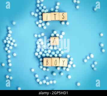 Its a Boy text written with wooden cubes with pastel blue background, Baby Shower or Nursery background Baby announcement. Flat lay,text space. top vi Stock Photo